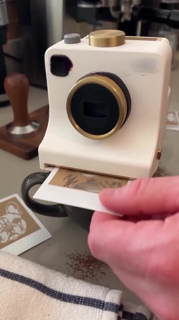 Coffee art camera pressing a design onto milk foam